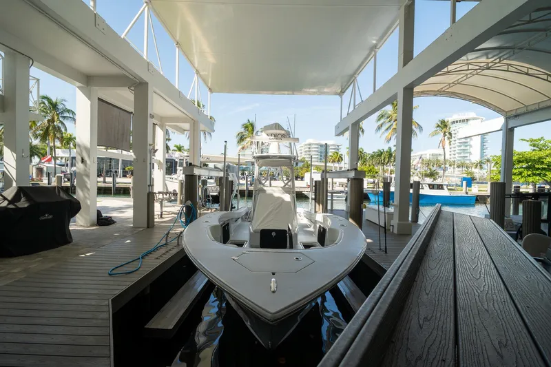 Slide: The Image of 2026 Conch 33 boat docked under a canopy in a marina setting. - 48