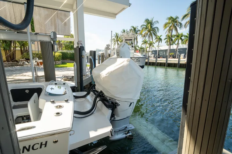 Slide: The Image of 2026 Conch 33 boat docked by palm trees, sunny waterfront setting. - 51