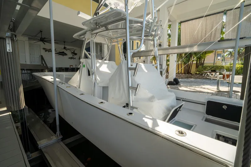 Slide: The Image of 2026 Conch 33 boat docked in a covered marina, showcasing sleek design and modern features. - 52