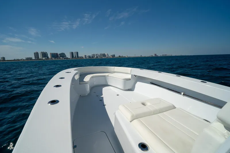 Slide: The Image of 2026 Conch 33 boat on open water with city skyline in background. - 7