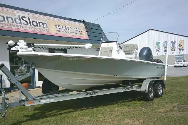 Slide: The Image of 2022 Sportsman Tournament 214 Bay Boat on trailer outside dealership. - 2