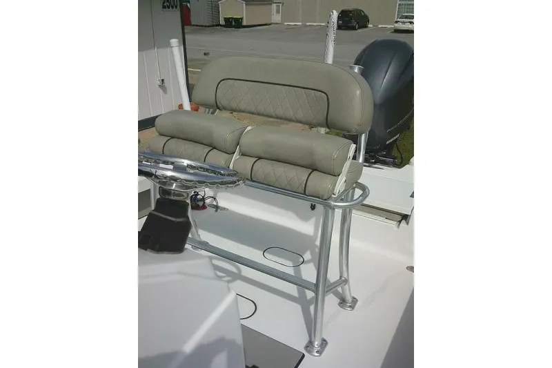 Slide: The Image of 2022 Sportsman Tournament 214 Bay Boat with cushioned seating and steering wheel. - 28