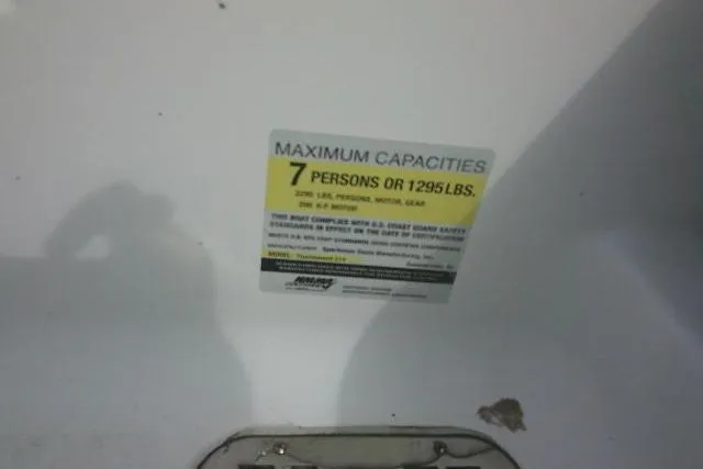 Slide: The Image of 2022 Sportsman Tournament 214 Bay Boat capacity label, max 7 persons or 1295 lbs. - 30