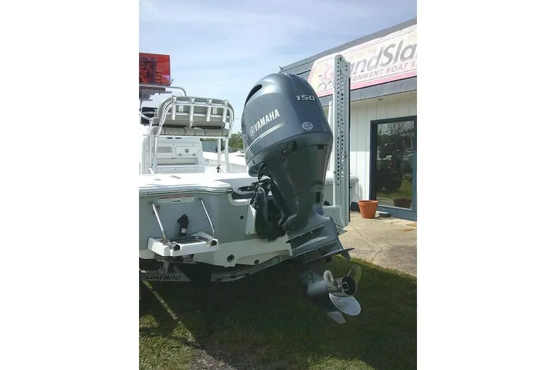 Slide: The Image of 2022 Sportsman Tournament 214 Bay Boat with Yamaha 150 engine displayed outdoors. - 4