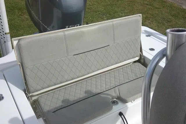 Slide: The Image of 2022 Sportsman Tournament 214 Bay Boat with cushioned seating and outboard motor. - 40