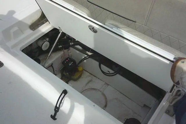 Slide: The Image of 2022 Sportsman Tournament 214 Bay Boat storage compartment with equipment and wiring. - 45