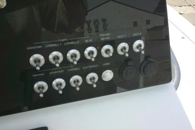 Slide: The Image of Control panel of a 2022 Sportsman Tournament 214 Bay Boat with various switches and outlets. - 48
