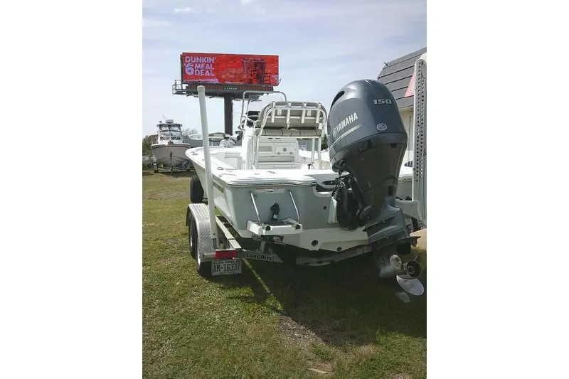 Slide: The Image of 2022 Sportsman Tournament 214 Bay Boat with Yamaha engine on trailer, outdoor display. - 5