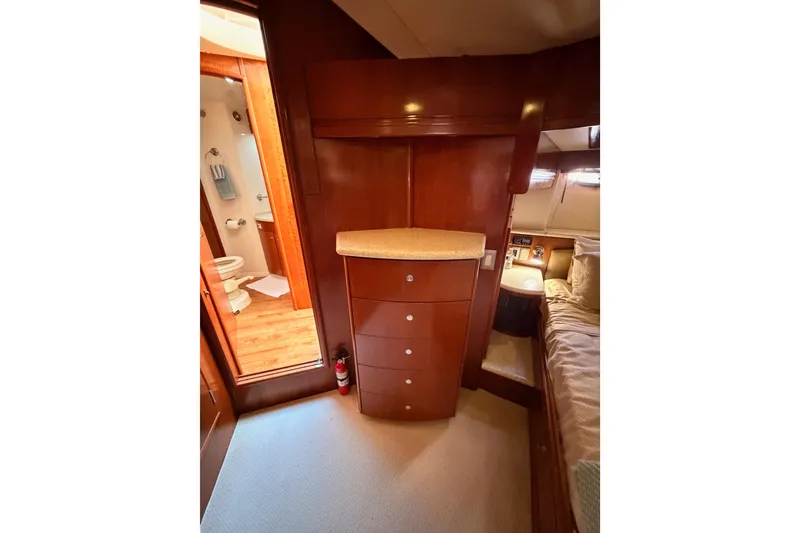 Slide: The Image of Interior of 1999 Carver 530 Voyager Pilothouse with wood cabinetry and adjacent bathroom. - 102