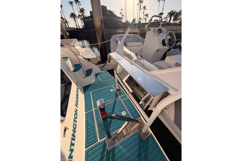 Slide: The Image of 1998 Sea Ray 420 Aft Cabin boat deck with blue flooring and steering wheel. - 10