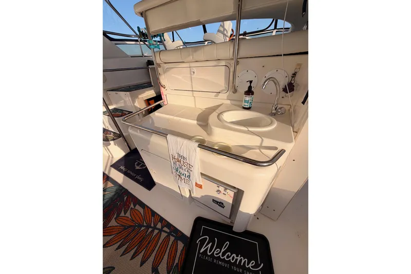 Slide: The Image of 1998 Sea Ray 420 Aft Cabin interior with sink, welcome mat, and nautical decor. - 22