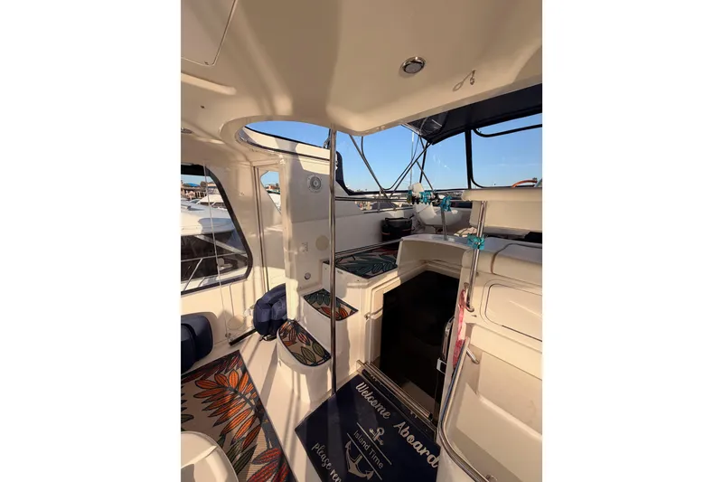 Slide: The Image of 1998 Sea Ray 420 Aft Cabin interior with seating and nautical decor. - 26