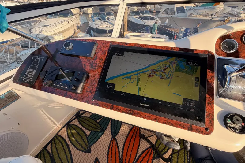 Slide: The Image of Cockpit of 1998 Sea Ray 420 Aft Cabin with navigation equipment and marina view. - 30