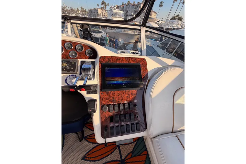 Slide: The Image of 1998 Sea Ray 420 Aft Cabin helm with controls and navigation screen. - 32