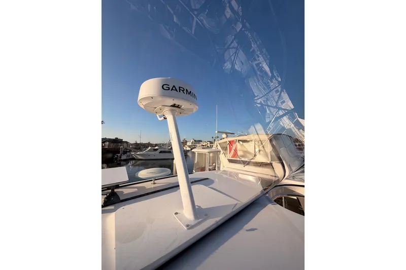 Slide: The Image of 1998 Sea Ray 420 Aft Cabin with Garmin radar, docked under clear blue sky. - 39