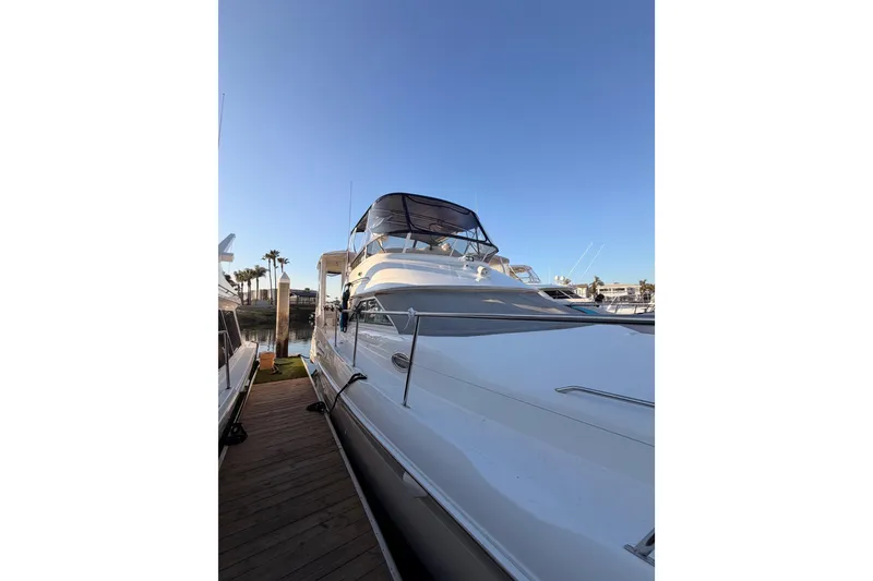 Slide: The Image of 1998 Sea Ray 420 Aft Cabin yacht docked under clear blue sky. - 4
