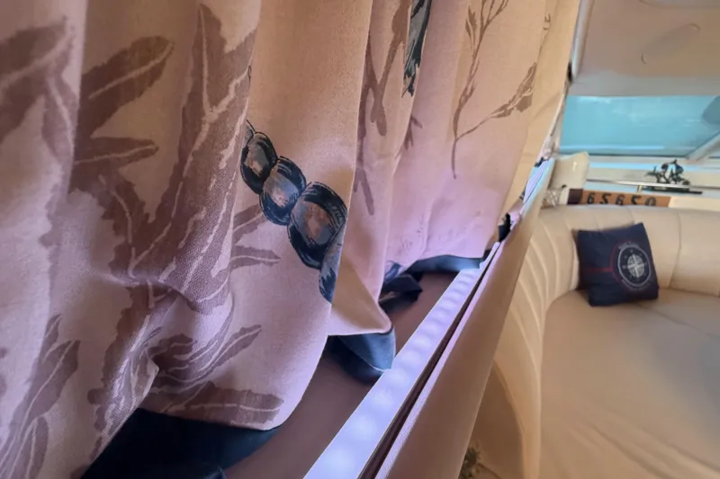 Slide: The Image of Interior of 1998 Sea Ray 420 Aft Cabin with decorative curtains and plush seating. - 44