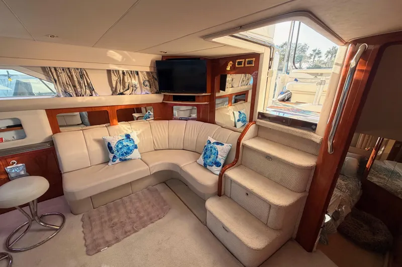 Slide: The Image of Luxurious 1998 Sea Ray 420 Aft Cabin interior with plush seating and elegant decor. - 46