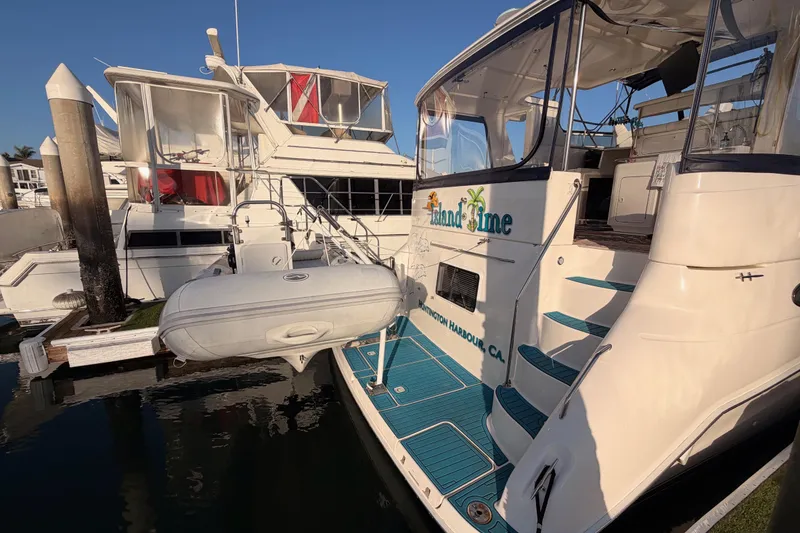 Slide: The Image of 1998 Sea Ray 420 Aft Cabin yacht docked with inflatable boat attached. - 6