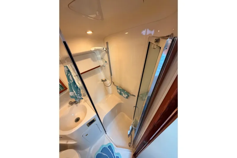 Slide: The Image of Bathroom interior of 1998 Sea Ray 420 Aft Cabin yacht, featuring shower and sink. - 60