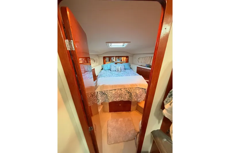 Slide: The Image of Cozy bedroom in 1998 Sea Ray 420 Aft Cabin yacht with elegant wood finish. - 62