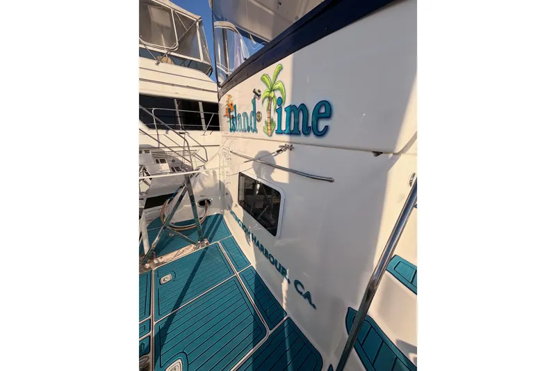 Slide: The Image of 1998 Sea Ray 420 Aft Cabin yacht with custom "Island Time" lettering and teal deck. - 8
