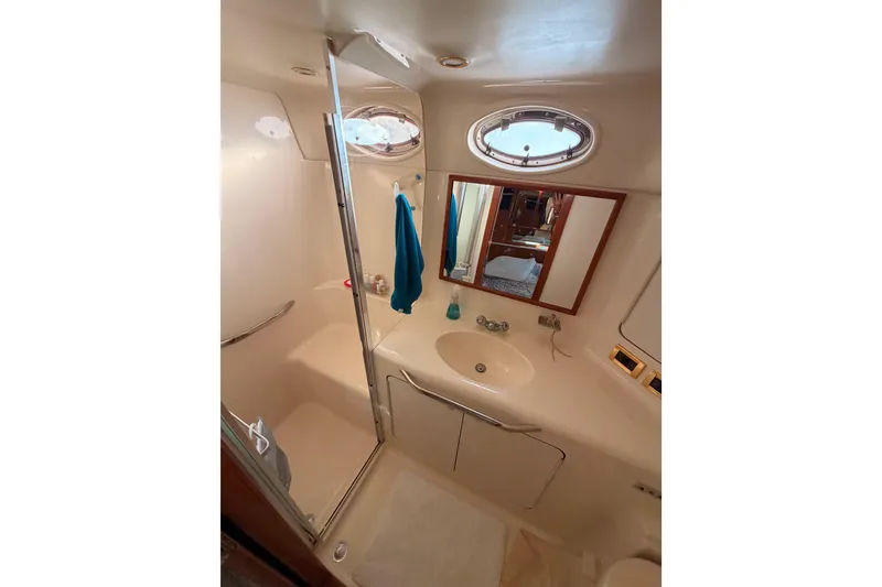 Slide: The Image of Bathroom interior of 1998 Sea Ray 420 Aft Cabin yacht, featuring shower and sink. - 81