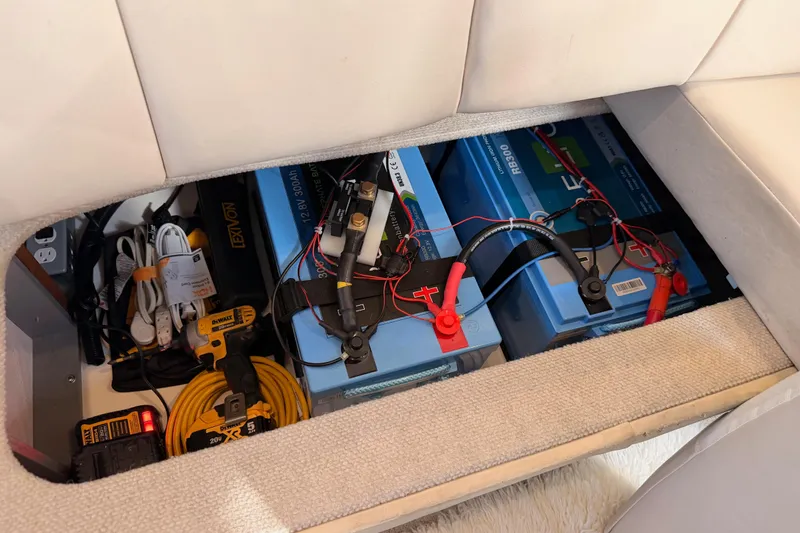 Slide: The Image of Battery compartment of a 1998 Sea Ray 420 Aft Cabin with tools and wiring. - 89