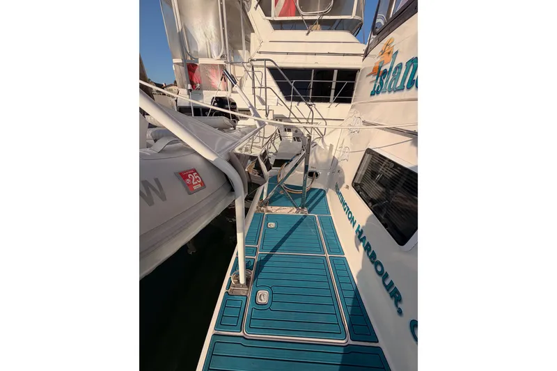 Slide: The Image of 1998 Sea Ray 420 Aft Cabin yacht with blue deck and railing. - 9