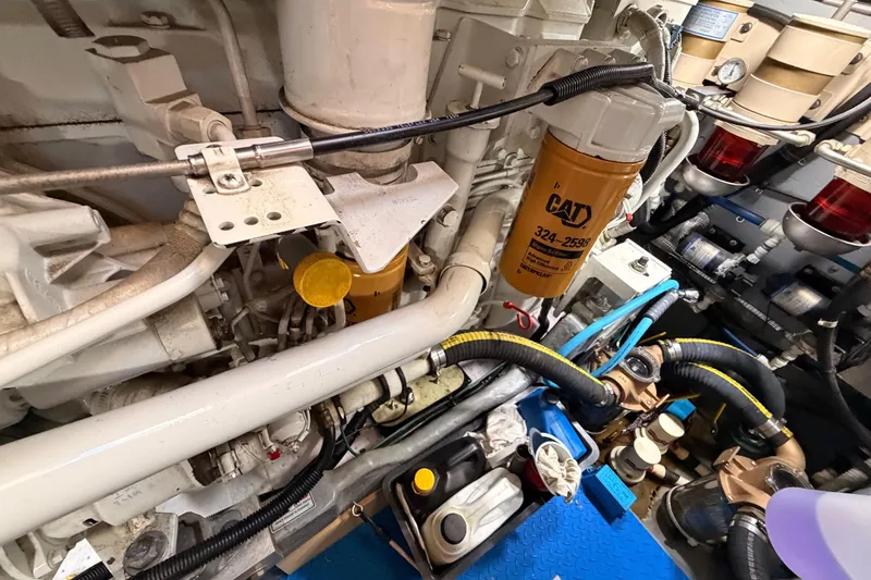 Slide: The Image of Engine room of 1998 Sea Ray 420 Aft Cabin with CAT oil filter and hoses. - 99