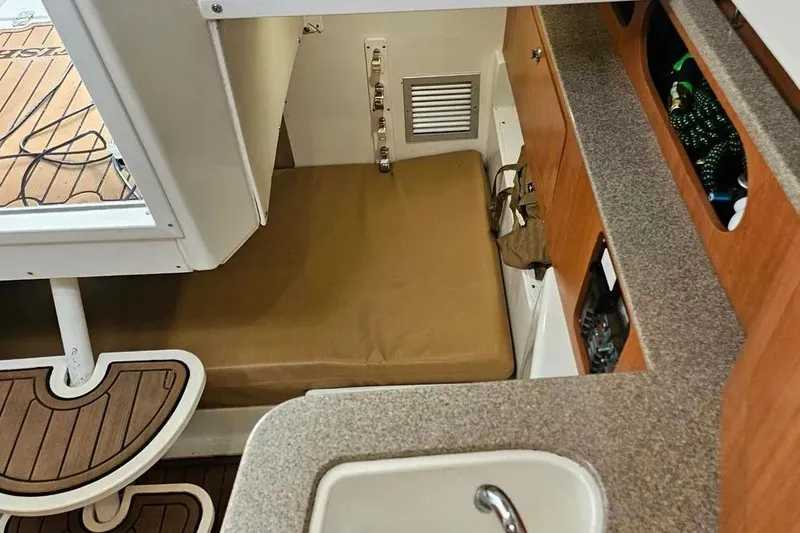 Slide: The Image of Interior cabin of 2007 Sailfish 30-06 Express boat with seating and storage. - 10