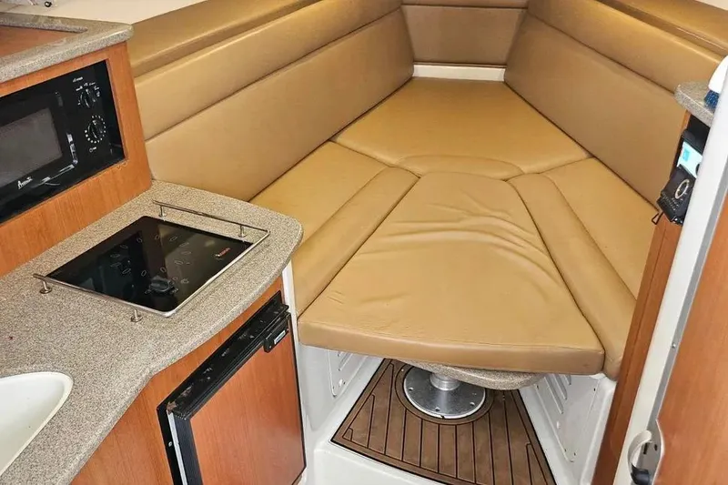 Slide: The Image of Interior of 2007 Sailfish 30-06 Express boat with cozy seating and kitchenette. - 14