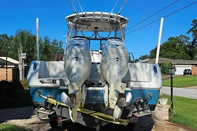 Slide: The Image of 2007 Sailfish 30-06 Express boat with dual outboard motors on a driveway. - 3