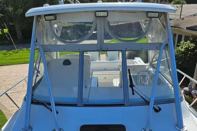 Slide: The Image of 2007 Sailfish 30-06 Express boat with clear windshield and canopy, docked outdoors. - 4