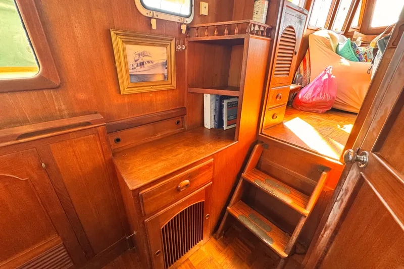 Slide: The Image of Interior of 1980 Hershine Trawler with wooden cabinetry and cozy seating area. - 12