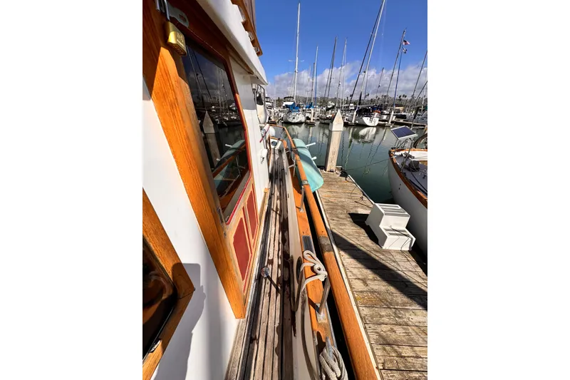 Slide: The Image of 1980 Hershine Trawler boat deck with wooden flooring and nautical equipment. - 15