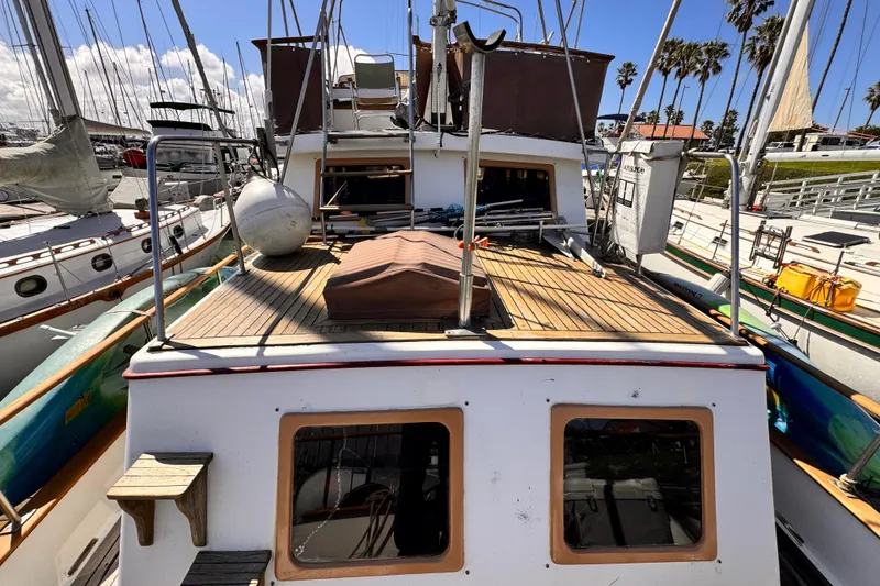 Slide: The Image of 1980 Hershine Trawler helm with wooden wheel, gauges, and nautical controls. - 18