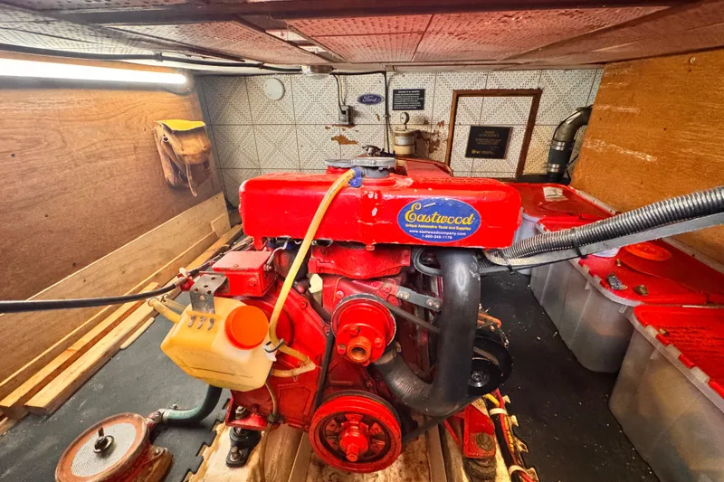 Slide: The Image of 1980 Hershine Trawler docked at marina, side view with wooden accents and nearby sailboats. - 21