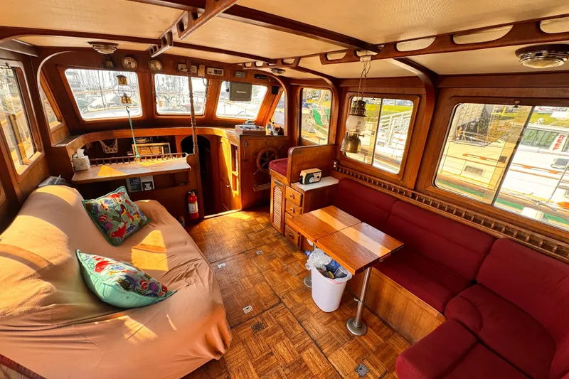 Slide: The Image of Interior of a 1980 Hershine Trawler with cozy seating and nautical decor. - 3
