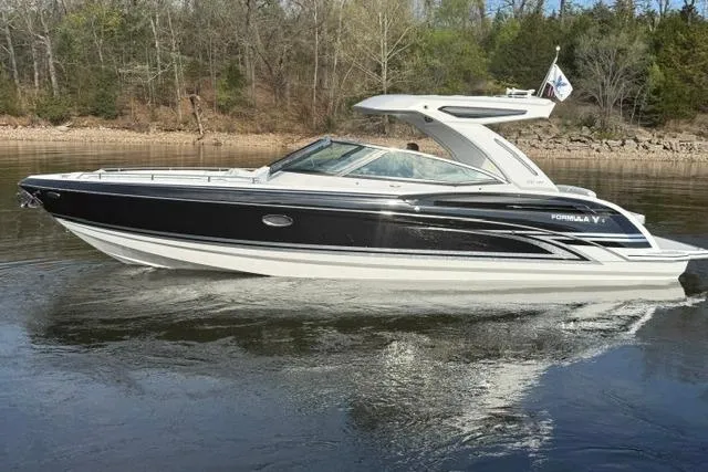 The Image of 2026 Formula 330 Crossover Bowrider I/O cruising on a calm lake. - 0