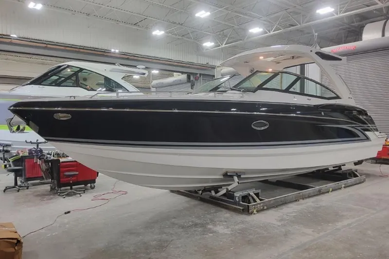 The Image of 2026 Formula 330 Crossover Bowrider I/O in a showroom, showcasing sleek design and modern features. - 1