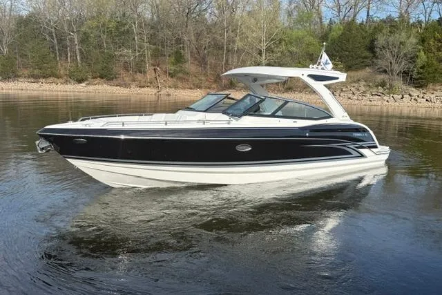 Slide: The Image of 2026 Formula 330 Crossover Bowrider I/O on calm water, surrounded by trees. - 13