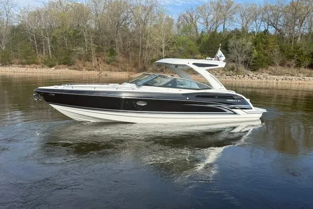 Slide: The Image of 2026 Formula 330 Crossover Bowrider I/O on calm water, surrounded by trees. - 14