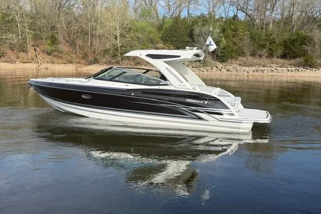 Slide: The Image of 2026 Formula 330 Crossover Bowrider I/O on calm water, showcasing sleek design and luxury features. - 16