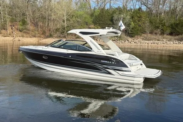 Slide: The Image of 2026 Formula 330 Crossover Bowrider I/O on calm water, surrounded by trees. - 17