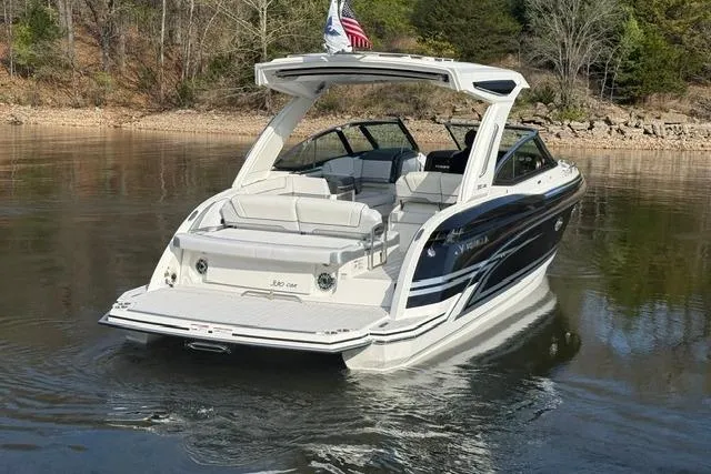 Slide: The Image of 2026 Formula 330 Crossover Bowrider I/O on calm lake with scenic background. - 18