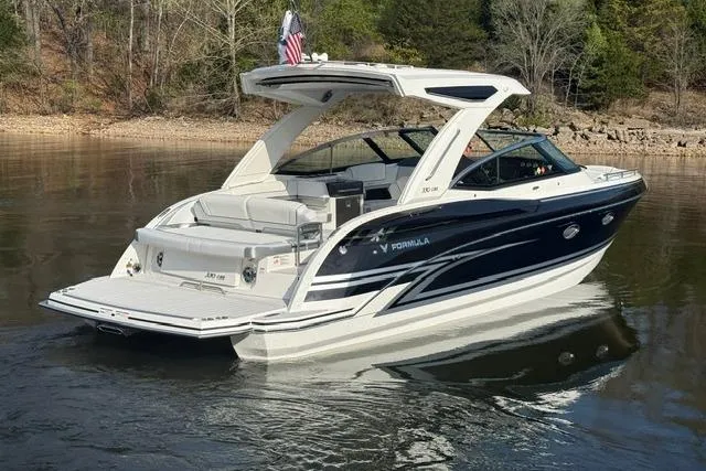 Slide: The Image of 2026 Formula 330 Crossover Bowrider I/O on calm water, showcasing sleek design and luxury features. - 19