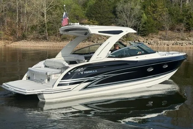 Slide: The Image of 2026 Formula 330 Crossover Bowrider I/O on calm lake with trees in background. - 20