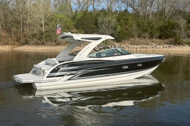 Slide: The Image of 2026 Formula 330 Crossover Bowrider I/O boat cruising on a calm lake. - 21