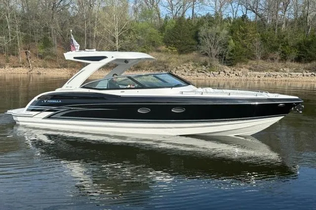 Slide: The Image of 2026 Formula 330 Crossover Bowrider I/O on calm water, showcasing sleek design and luxury features. - 23